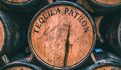 Close up of brown aged barrel labeled “Tequila Patron”.