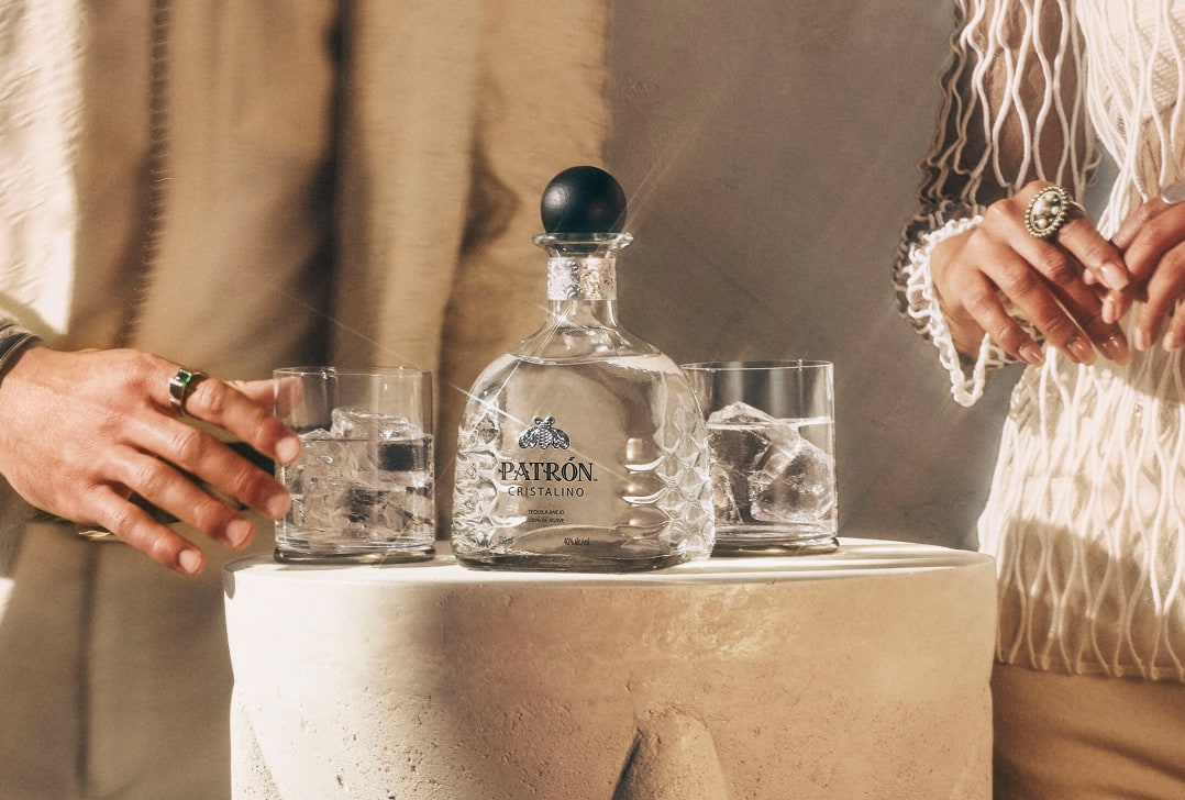 Patrón Cristalino bottle and Patrón Cristalino served on the rocks.