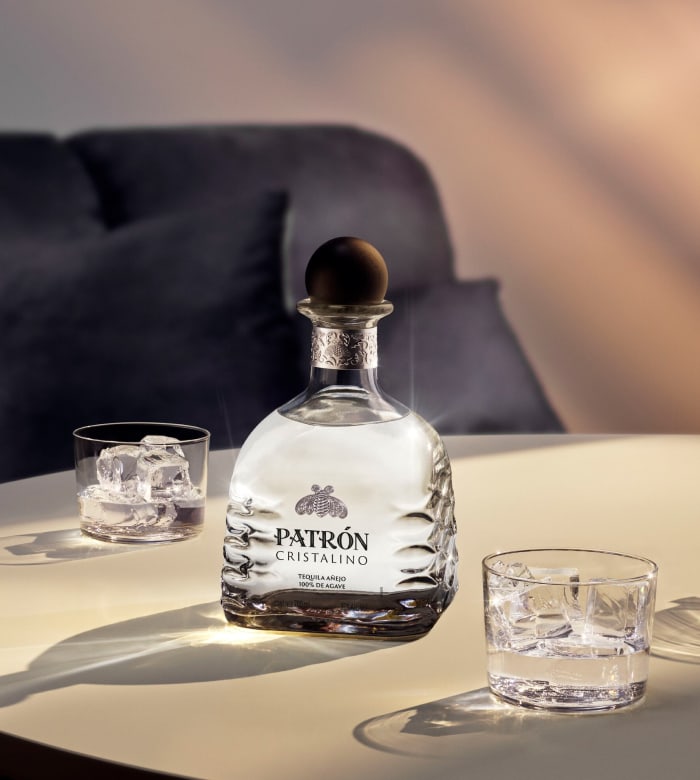 Patrón Cristalino bottle and Patrón Cristalino served on the rocks.